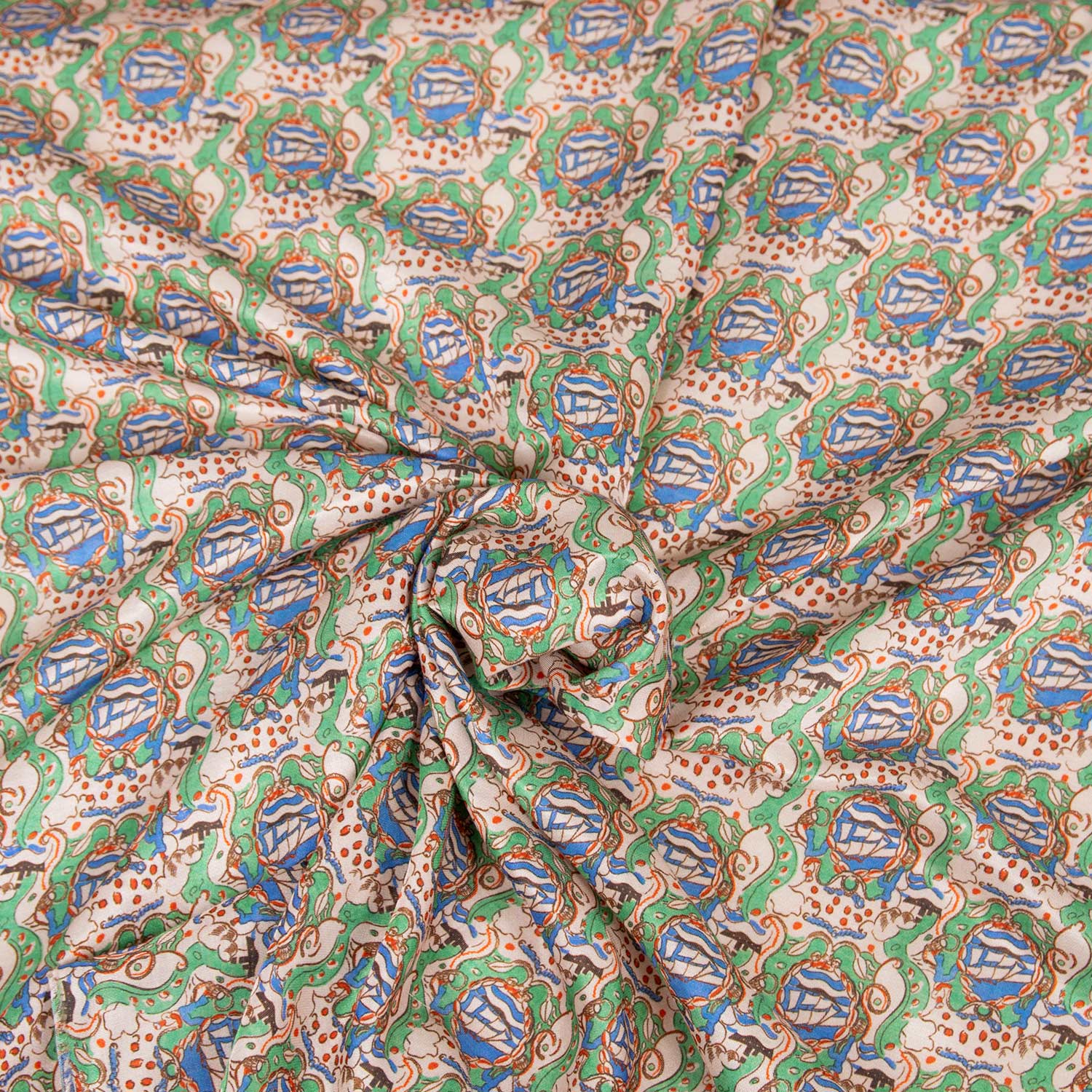 Deadstock stoffa leggera in raso 30% seta 70% cotone con stampa ispirata a mondi fantastici, colori verde, azzurro e rosso su fondo beige.