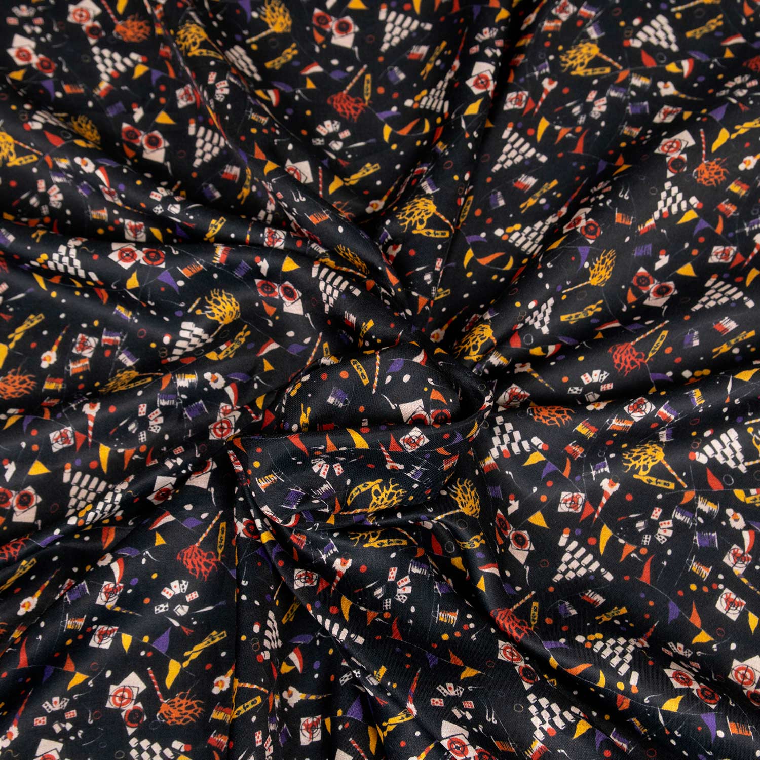 Tessuto charmeuse in raso leggero 70% cotone 30% seta, fondo nero con piccoli motivi multicolor stampati ispirati al circo, stoffa da abbigliamento deadstock made in Italy, venduta al metro.