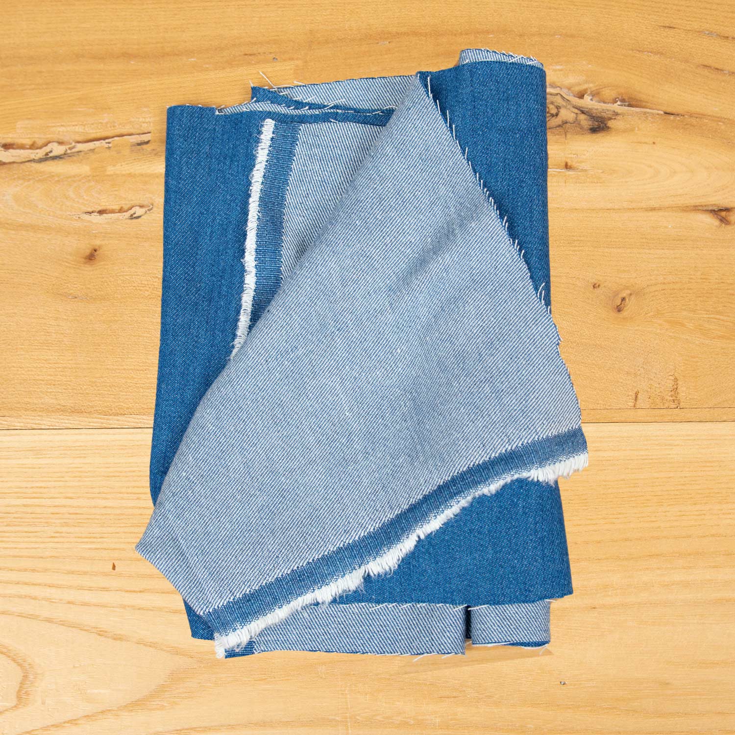 Primo piano tessuto denim blu chiaro deadstock in fibra Tencel 100%, superficie lavata e confortevole ideale per overshirt, pantaloni e giacche.
