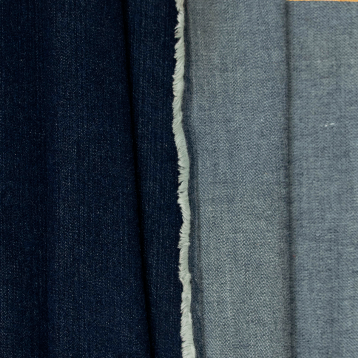 Denim blu scuro lavato elasticizzato, tessuto deadstock in ampia metratura per jeans e abbigliamento.